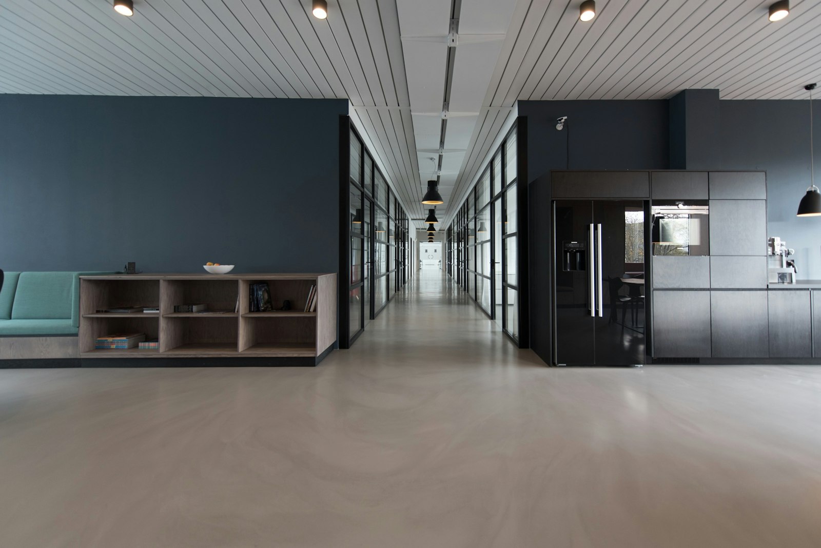 Wide view of the Profit AI Clash practice loft floor in Tanjong Pagar, with practice stations and screens set for a live rep session