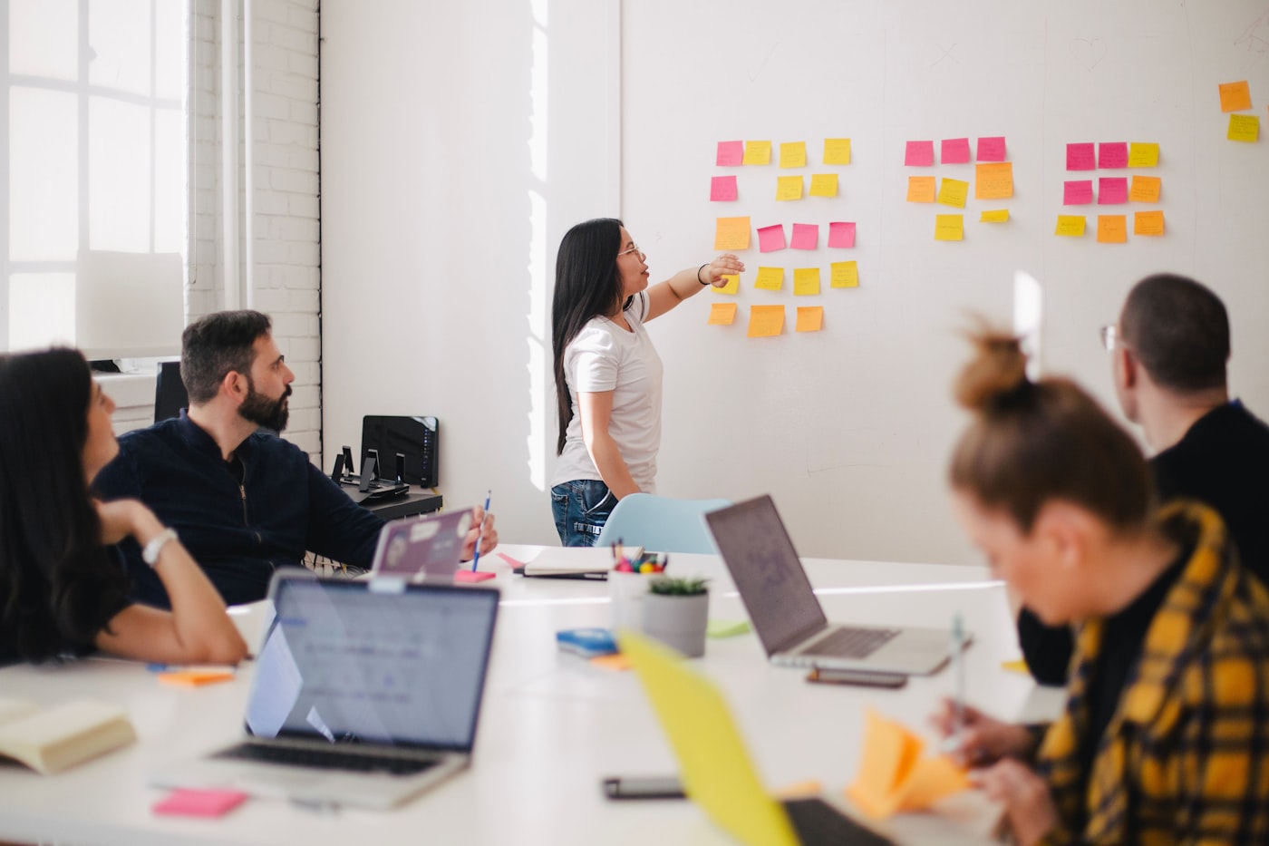 Facilitator leading a small-group AI profit skills session at the Tanjong Pagar practice loft